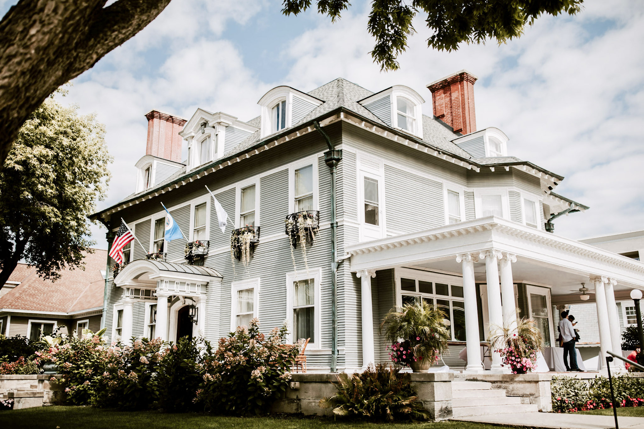The white Georgian Revival facade and wraparound porch of the 300 Clifton mansion in Loring Park, a little over a mile from Target Center in downtown Minneapolis
