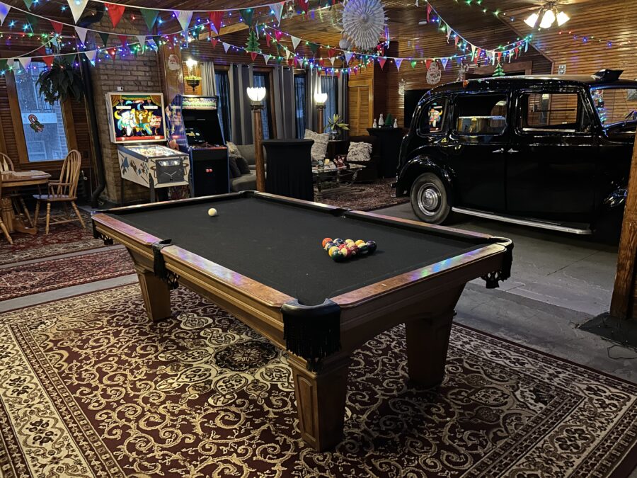 media room with pool table, stand up video game console, pinball, and an antique car