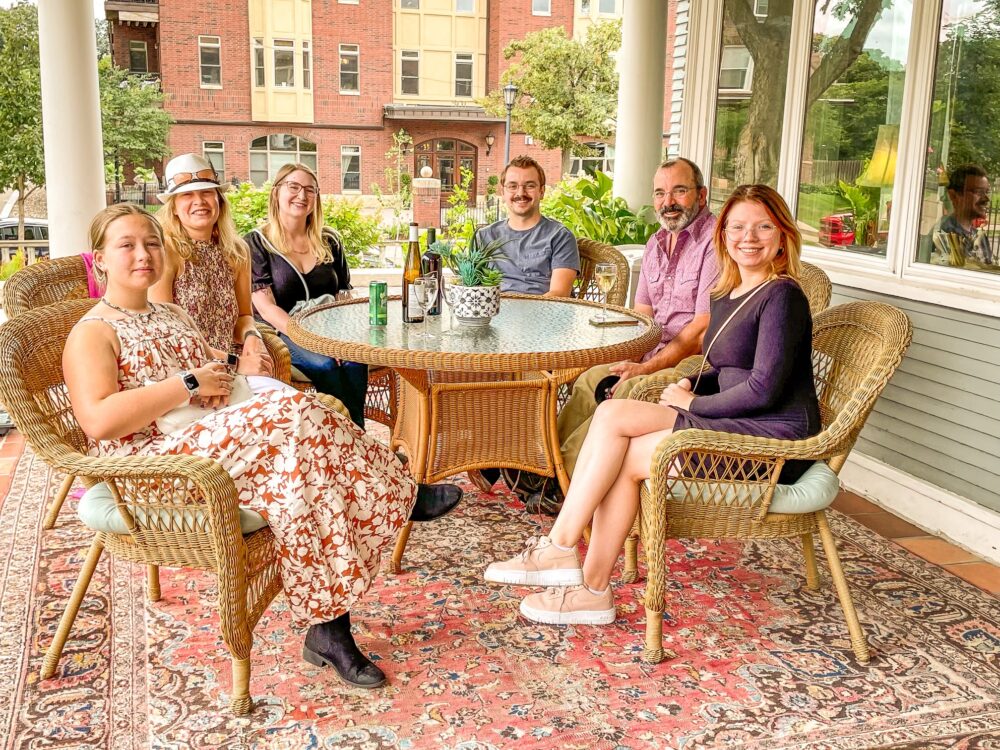 Guests relaxing together on the veranda at 300 Clifton bed and breakfast, a welcoming gathering spot during a Minneapolis Pride weekend getaway