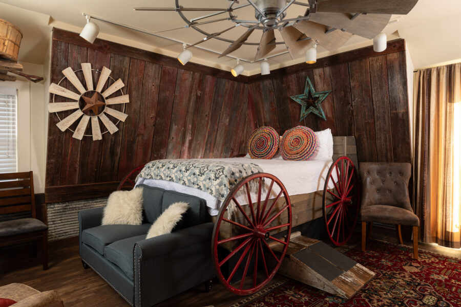 Sleep in a wagon bed in a hayloft themed room